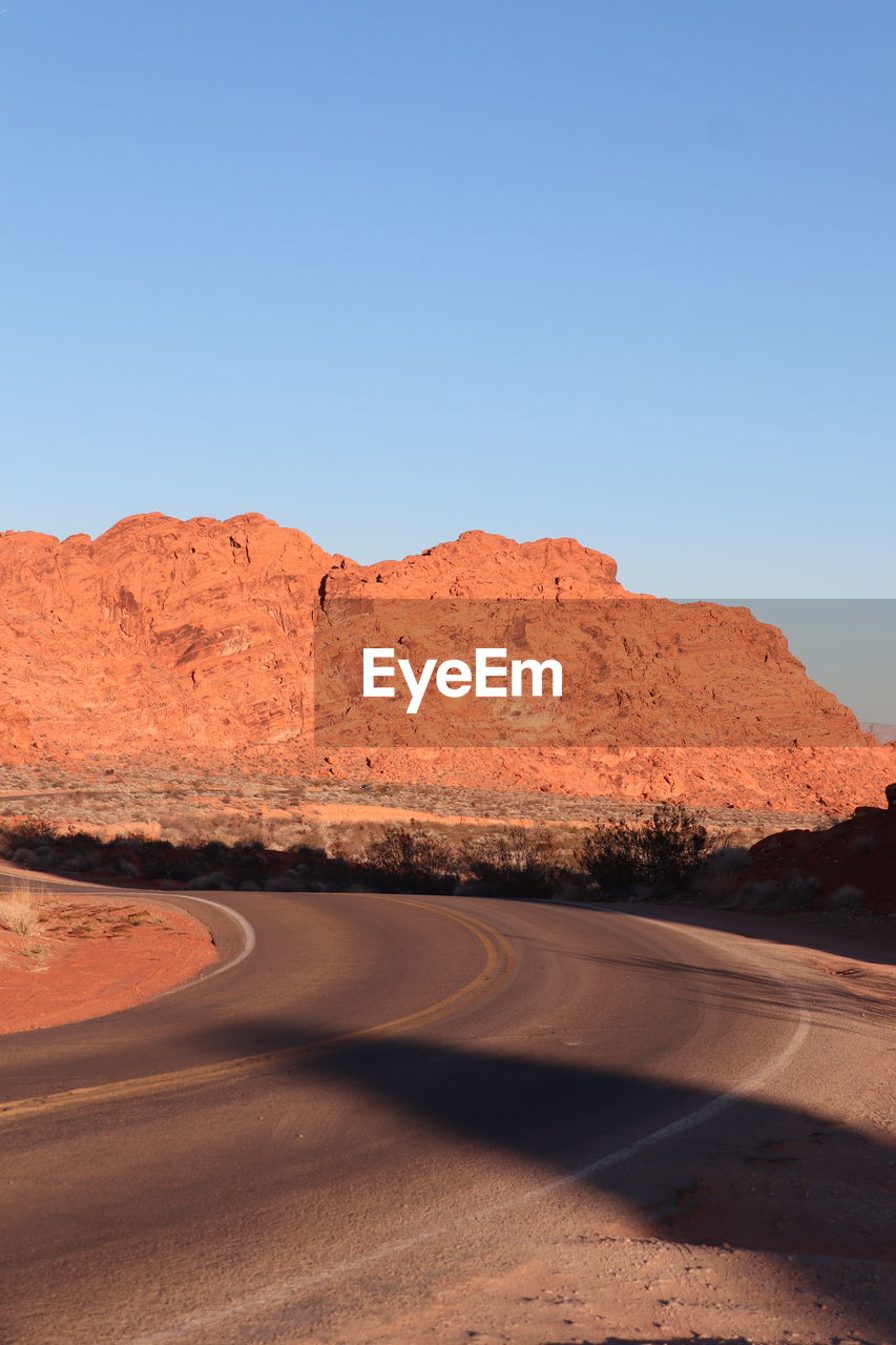 low angle view of rock formation against clear blue sky