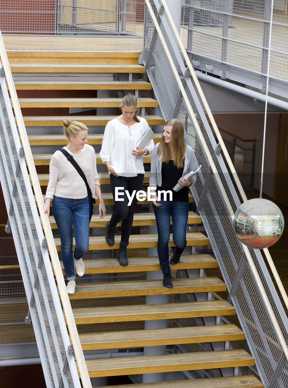 Three university student on stairs