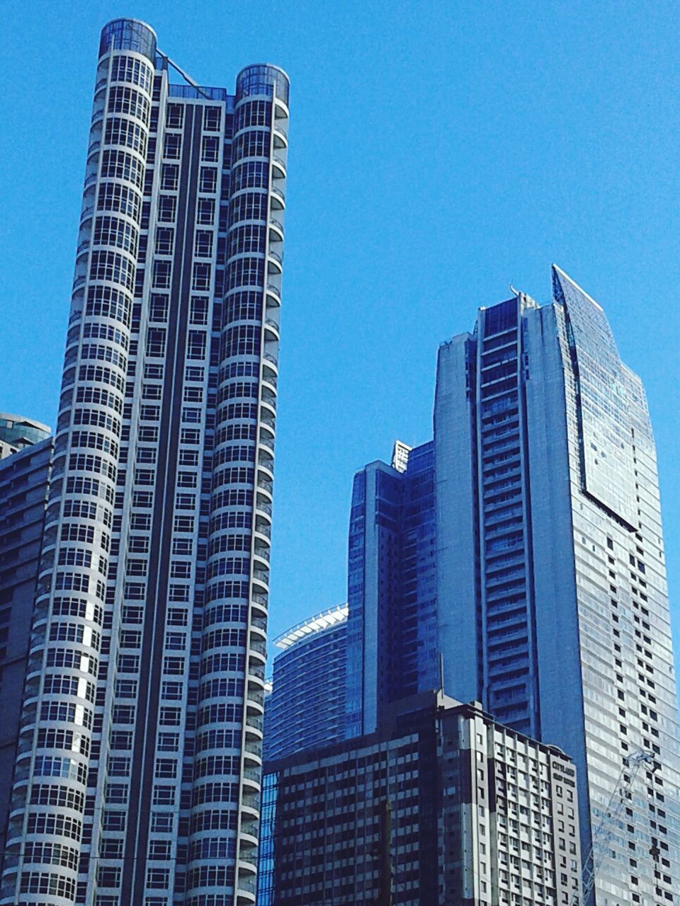 LOW ANGLE VIEW OF MODERN BUILDINGS AGAINST CLEAR SKY