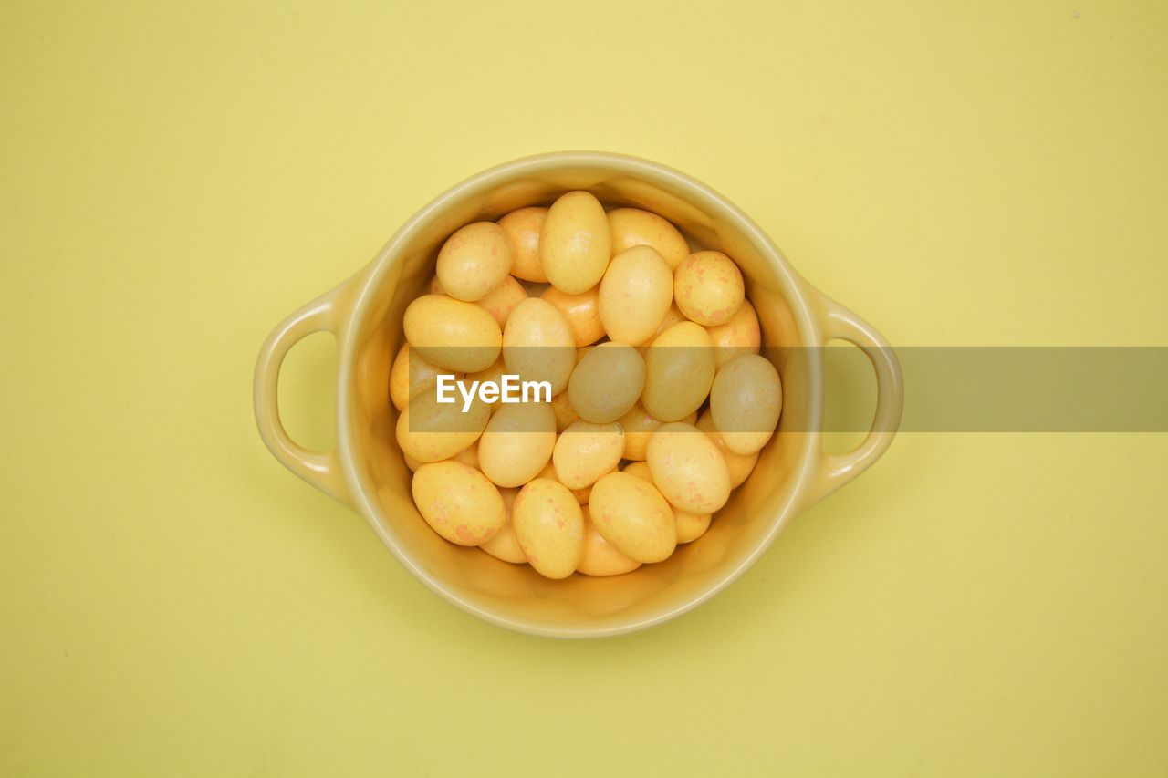 Directly above shot of easter eggs candies in bowl