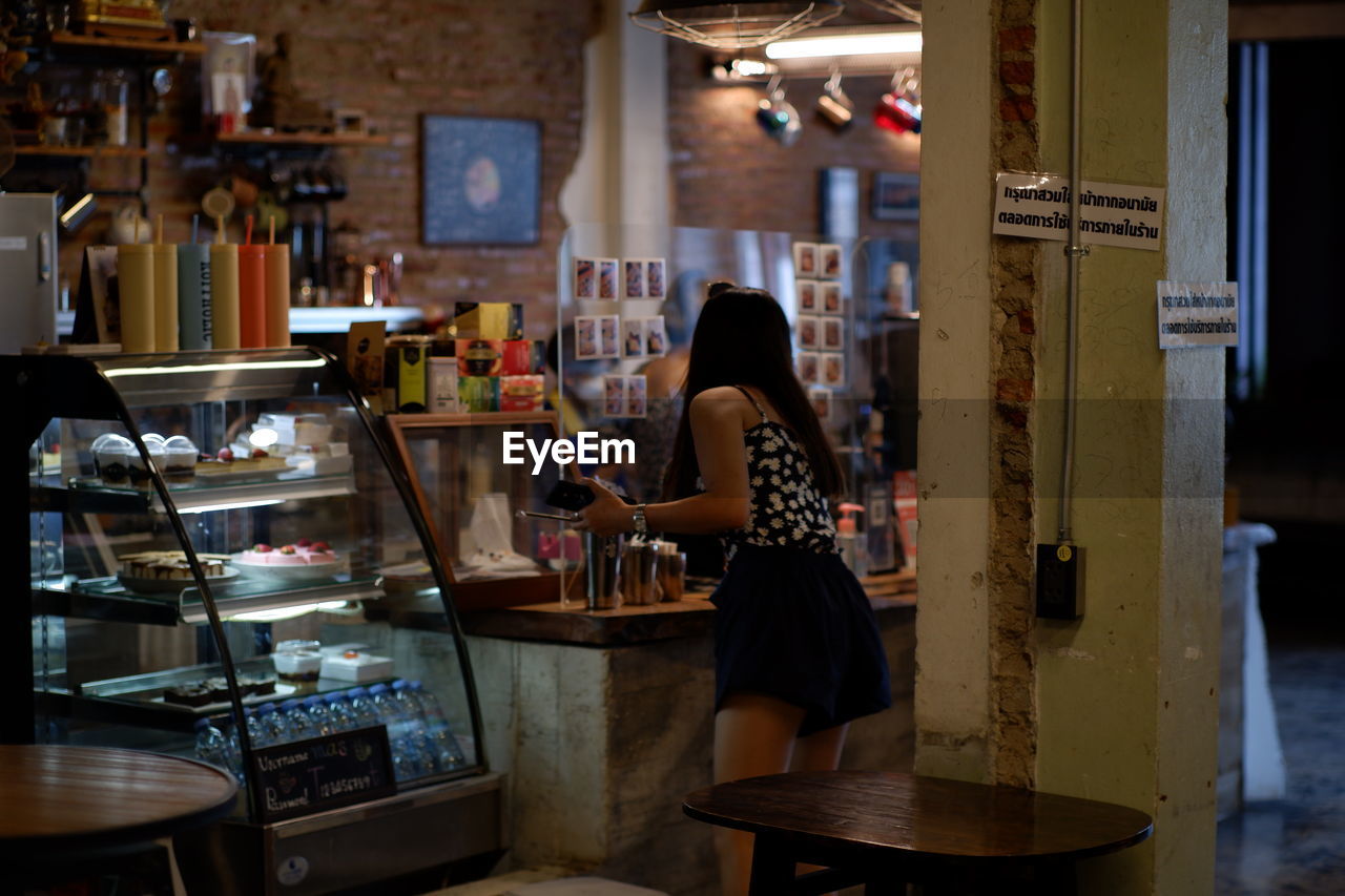 Woman standing in cafe