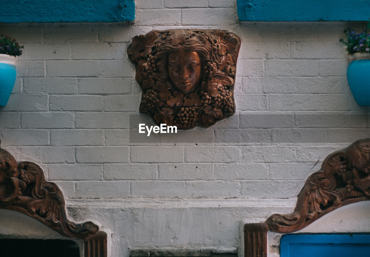 Human sculpture carved on wall