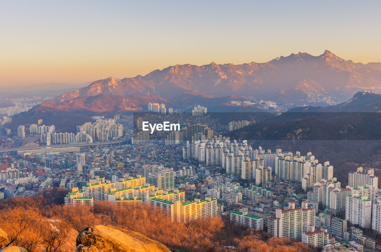 Aerial view of cityscape against sky during autumn