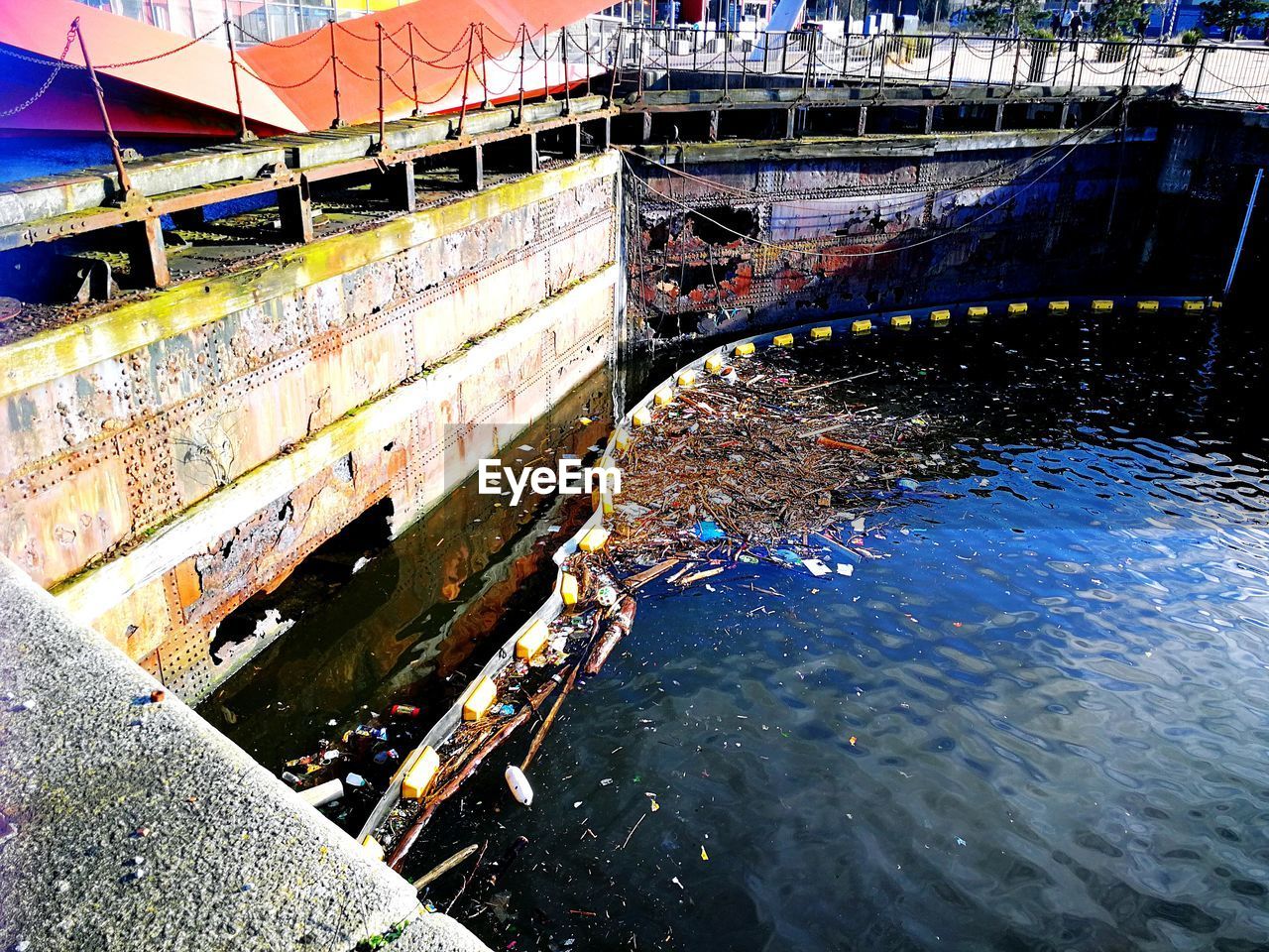 HIGH ANGLE VIEW OF CANAL ALONG BUILT STRUCTURES