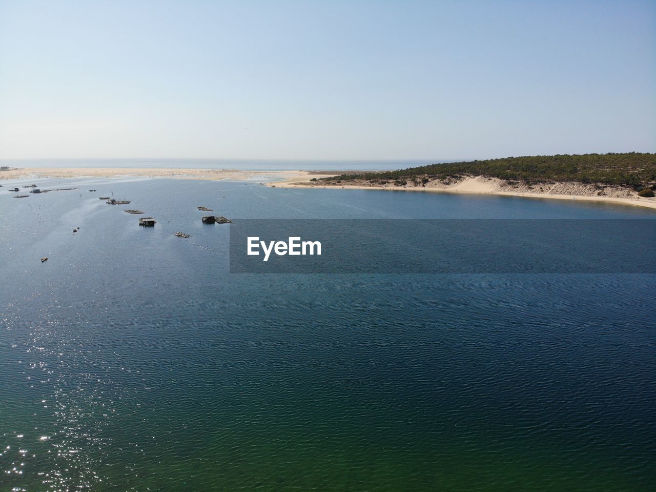 SCENIC VIEW OF SEA SHORE AGAINST CLEAR SKY