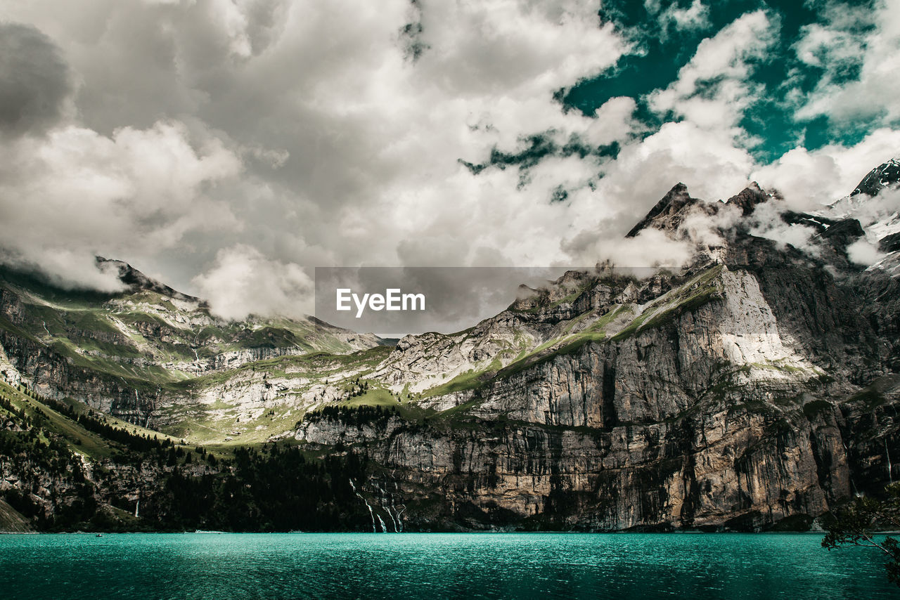 Scenic view of sea and mountains against sky