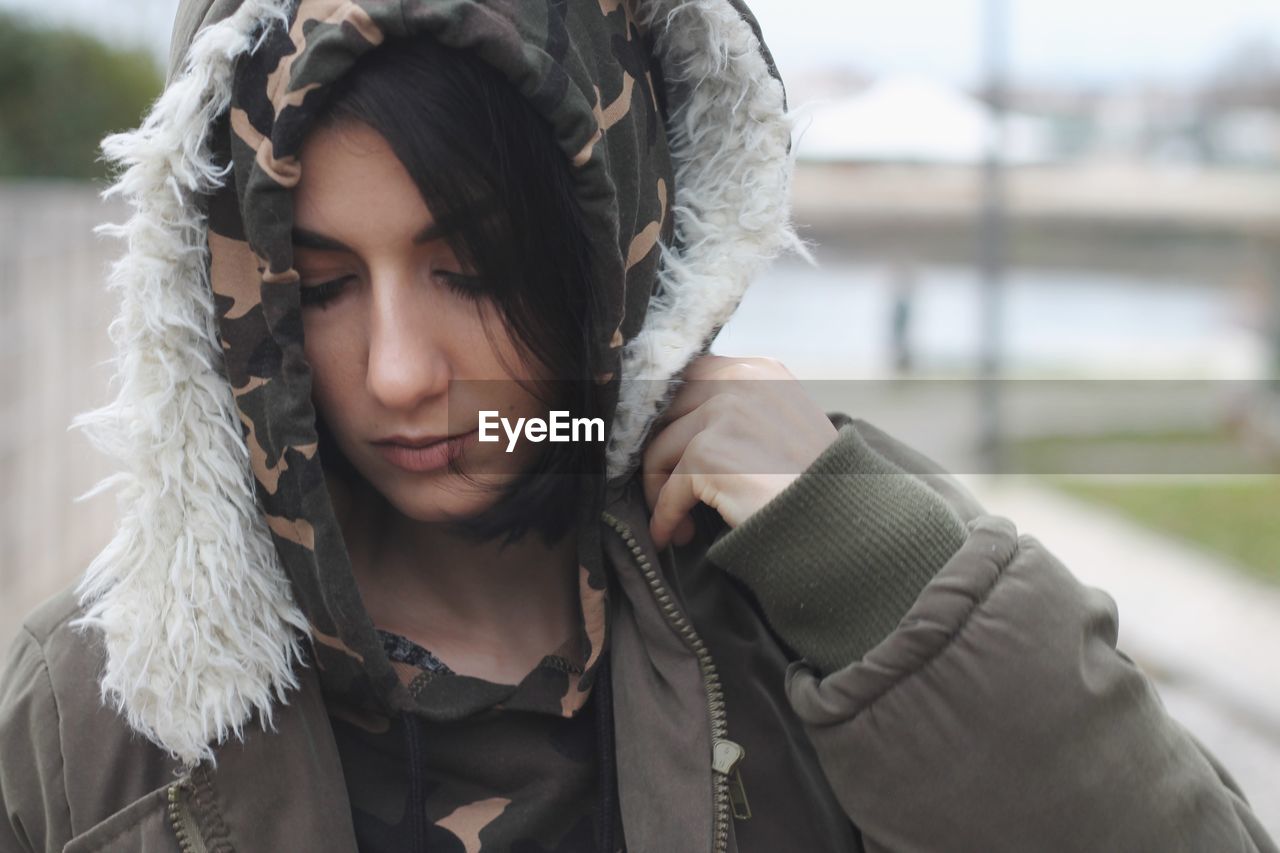 Close-up of beautiful young woman in warm clothes