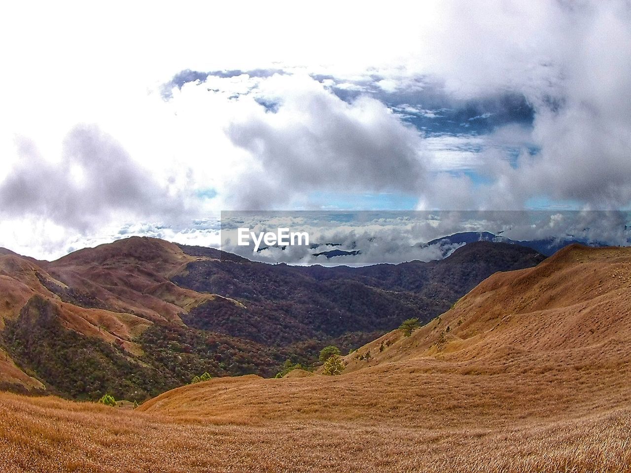 SCENIC VIEW OF CLOUDS OVER MOUNTAIN