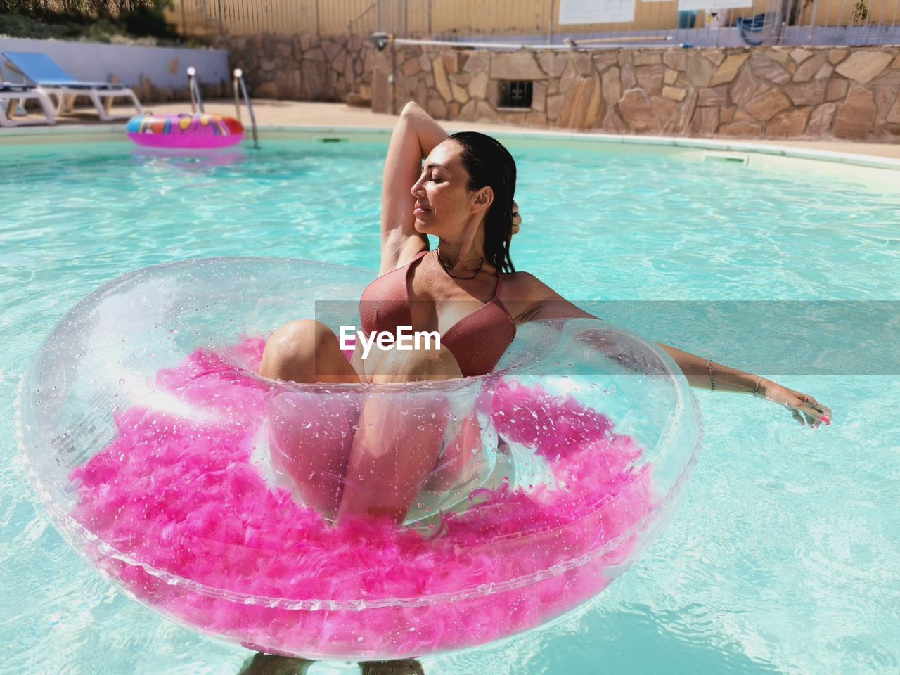 portrait of young woman swimming in pool