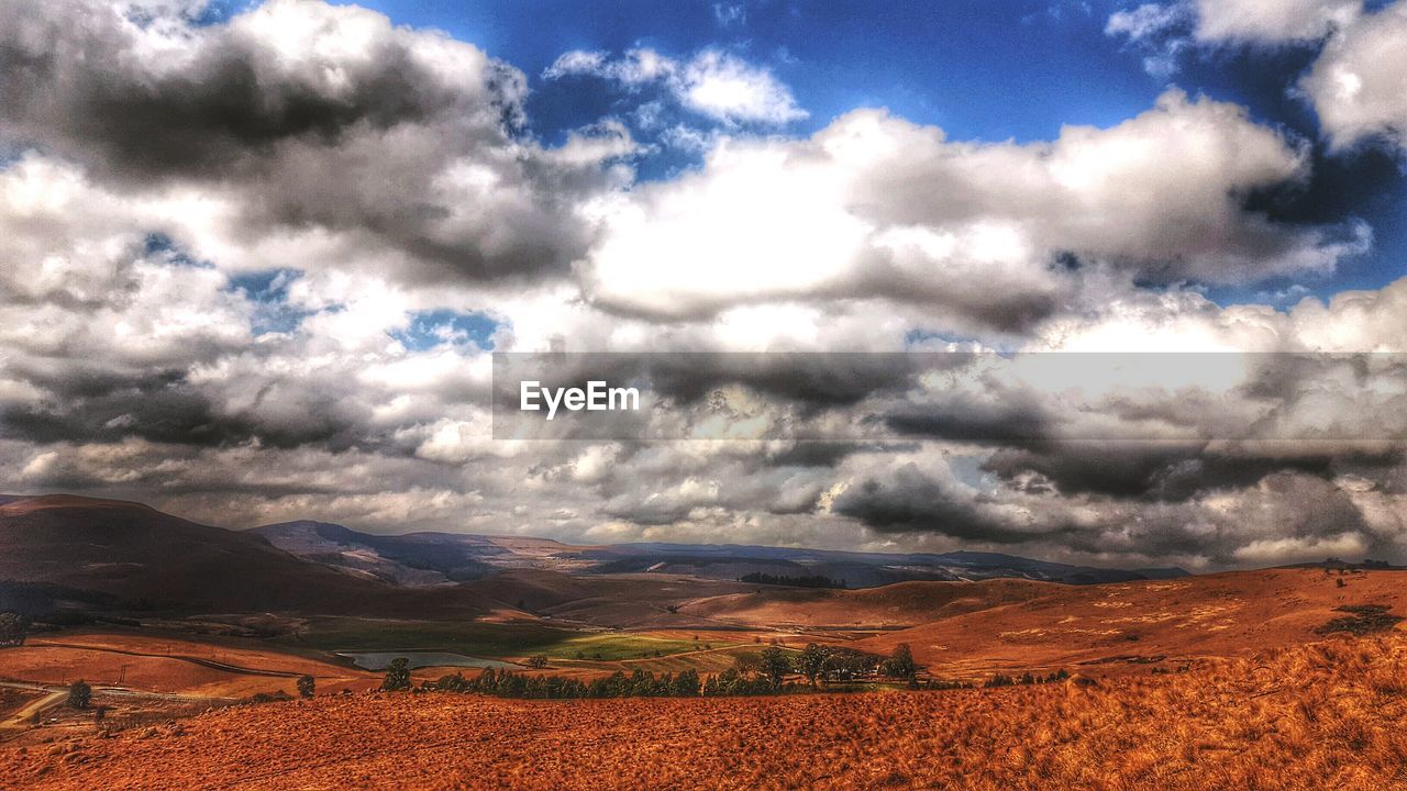 SCENIC VIEW OF FIELD AGAINST CLOUDY SKY