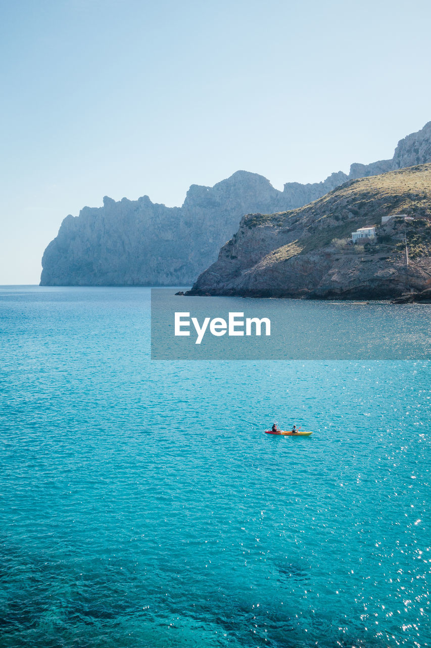 water, sea, scenics - nature, beauty in nature, sky, nature, land, nautical vessel, blue, travel, tranquility, ocean, transportation, mountain, tranquil scene, bay, travel destinations, holiday, trip, vacation, beach, coast, day, idyllic, turquoise colored, clear sky, body of water, island, mode of transportation, environment, outdoors, tourism, relaxation, landscape, islet, non-urban scene, leisure activity, shore, seascape, rock, sunny, lagoon, coastline, summer, adventure, cliff, no people, horizon