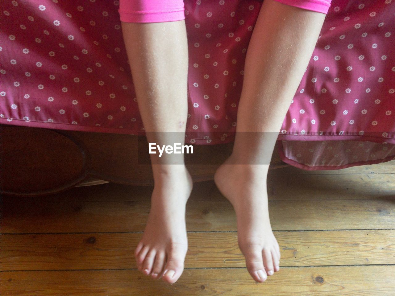 LOW SECTION OF WOMAN STANDING ON FLOOR AT HOME