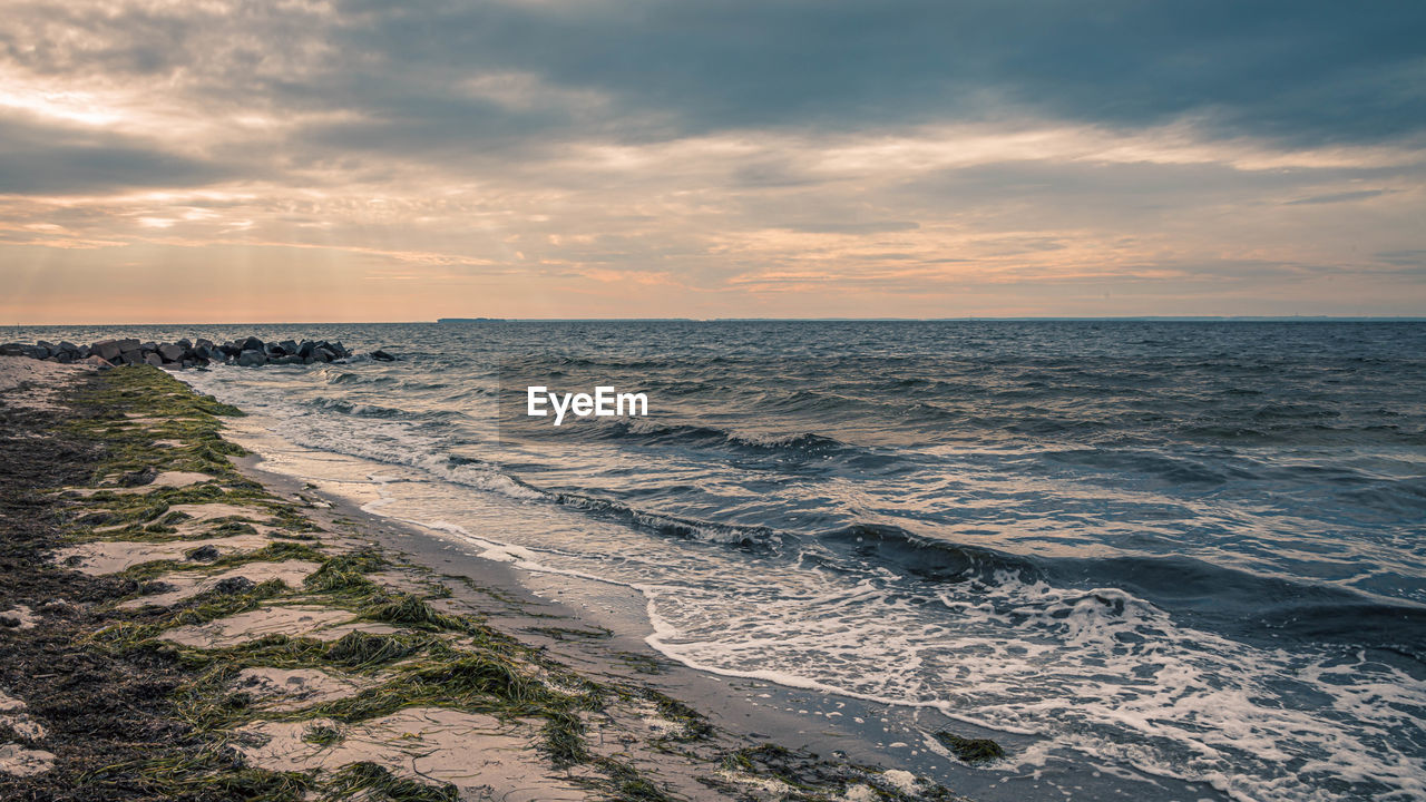 scenic view of sea against cloudy sky