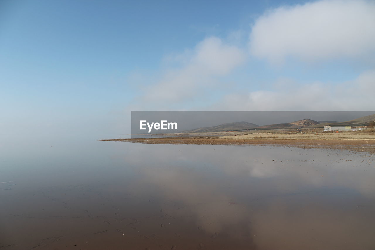 Scenic view of salt lake against sky