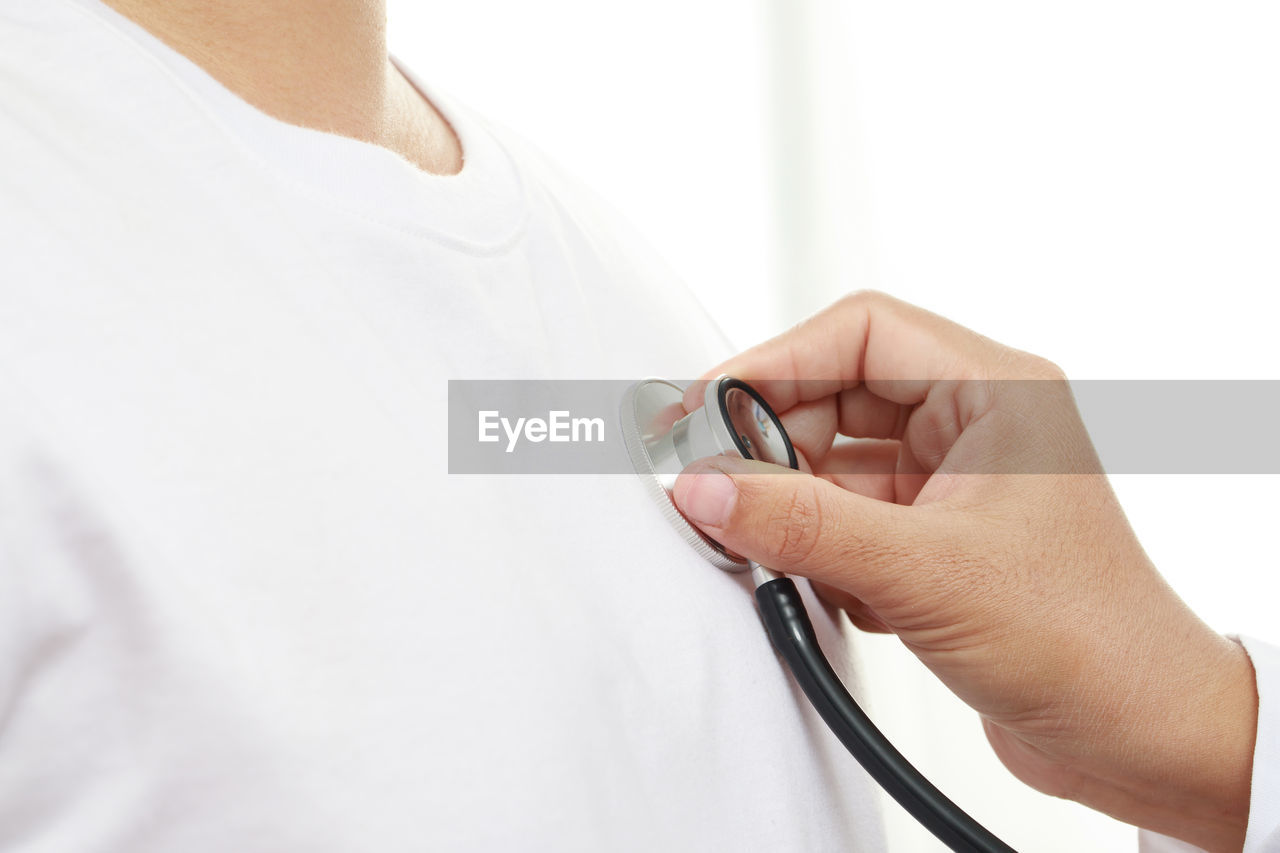 Doctor checking heart wave with patient at hospital