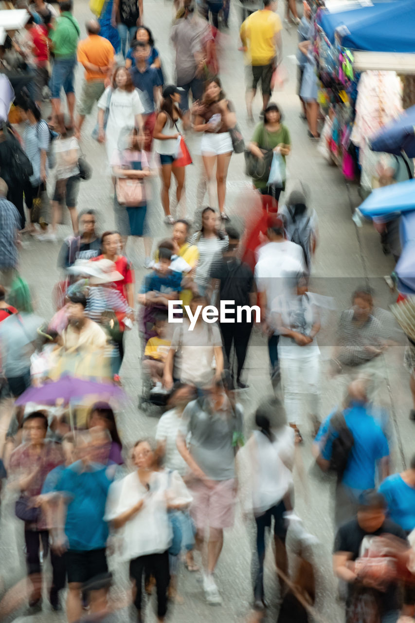 High angle view of people walking on street in city