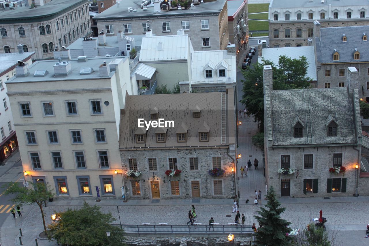 HIGH ANGLE VIEW OF STREET AMIDST BUILDINGS