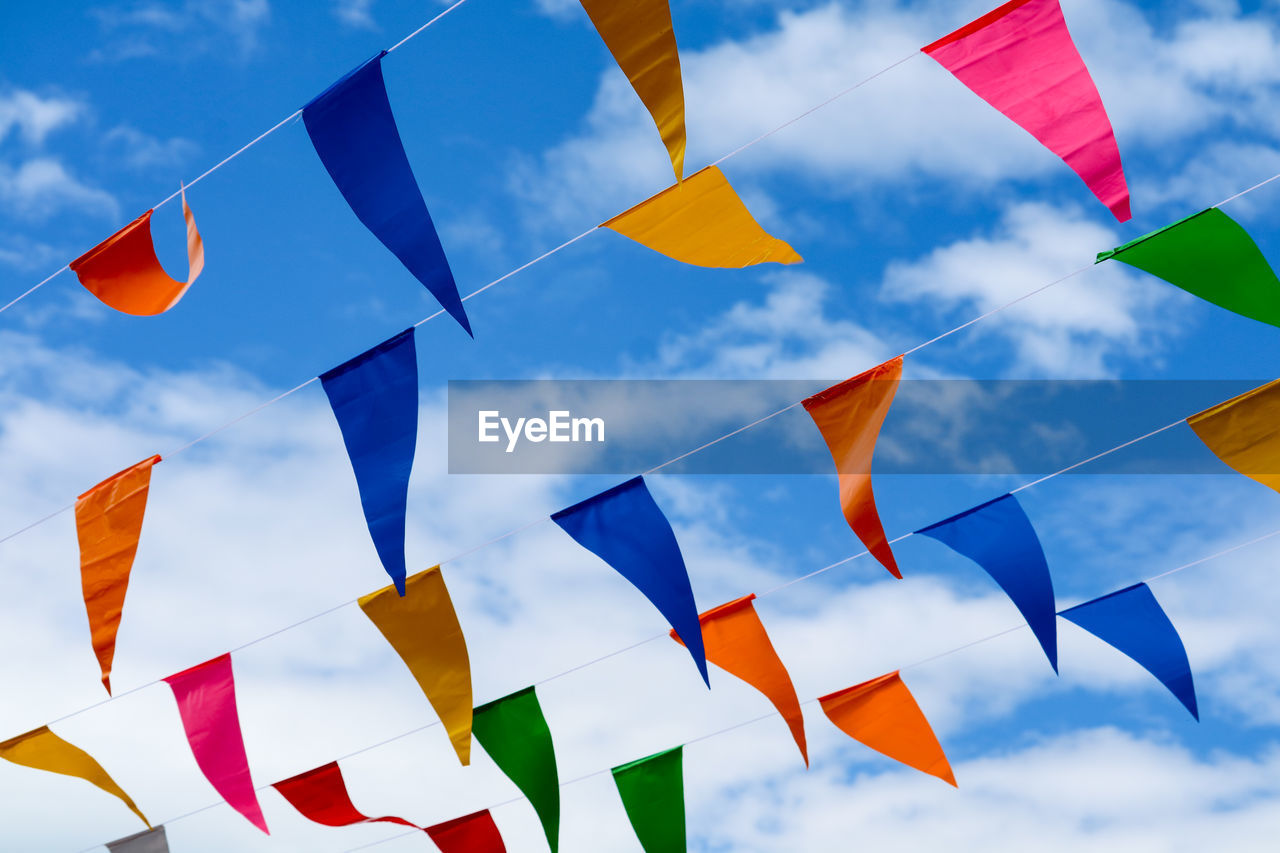 Low angle view of flags against sky