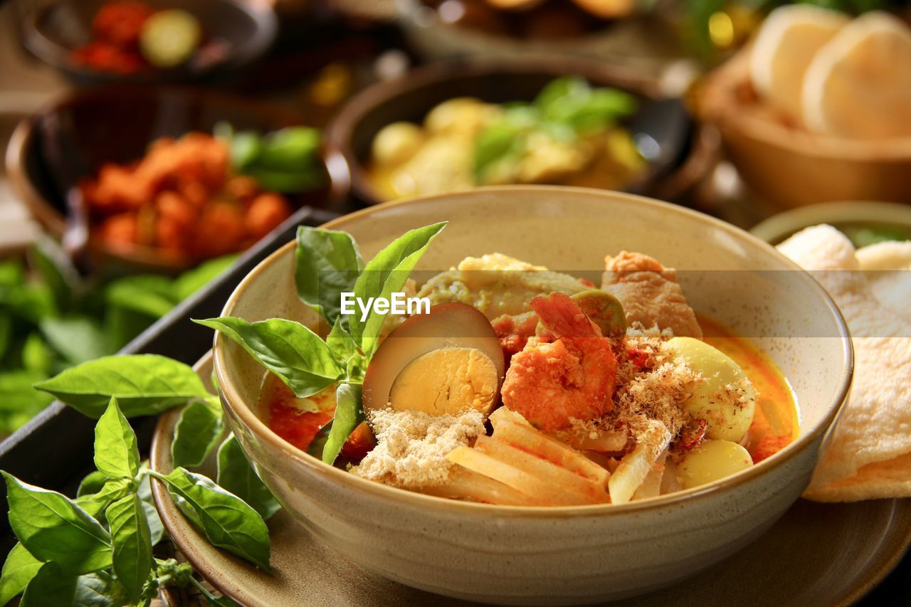 Lontong cap go meh, the peranakan dish of rice cake with chicken curry soup, spicy shrimps, tea egg