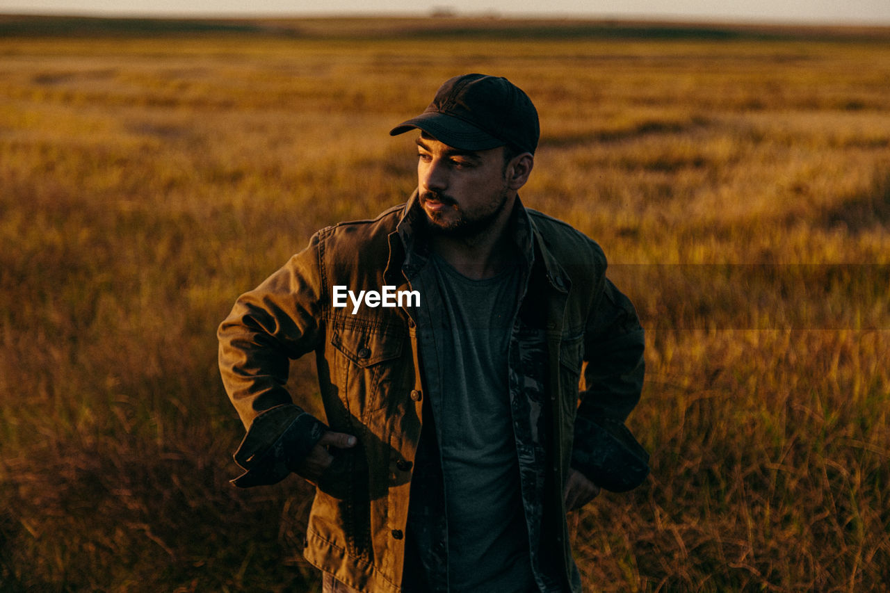 Portrait of a man in a field at sunset