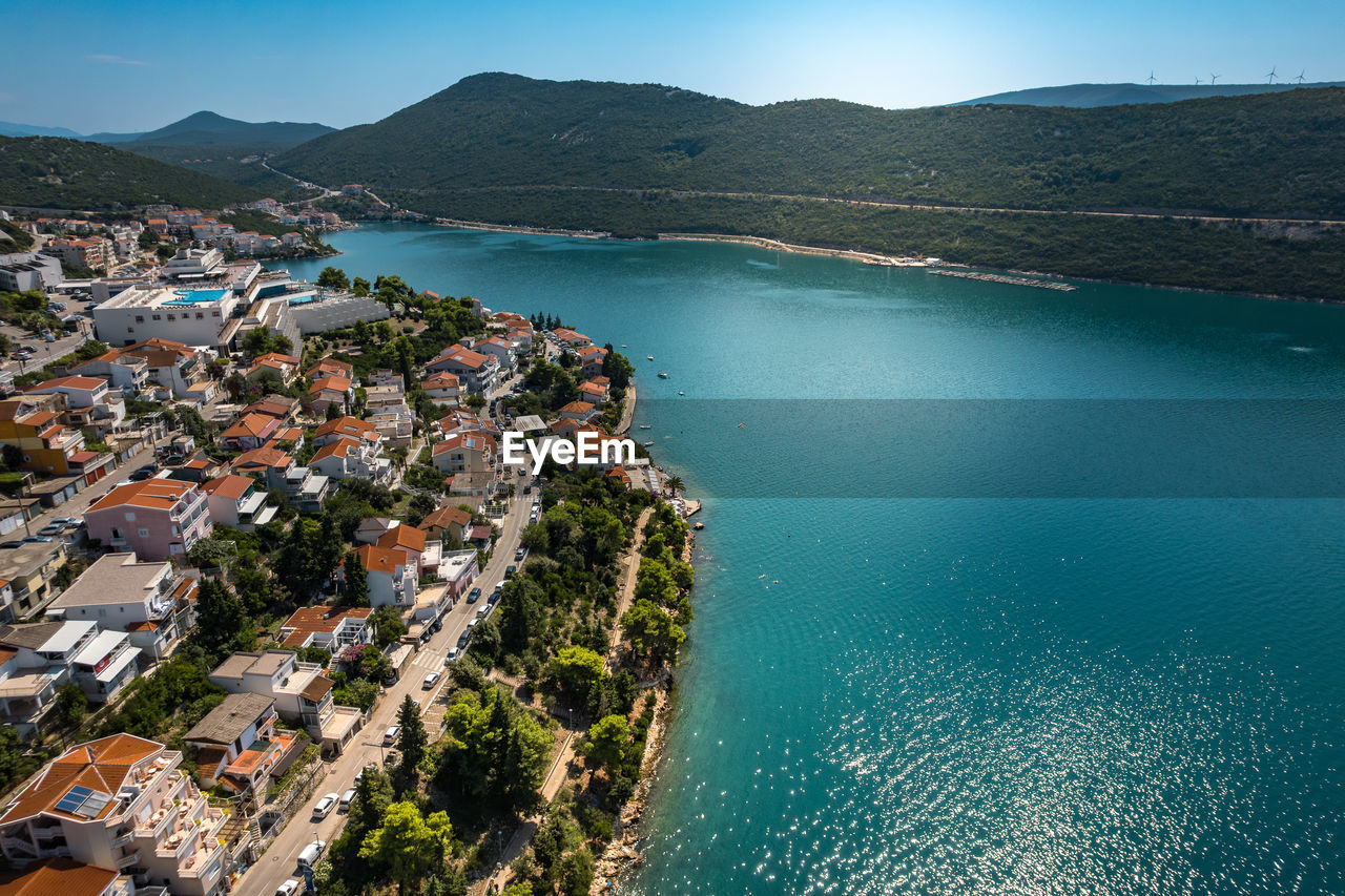 high angle view of city by sea