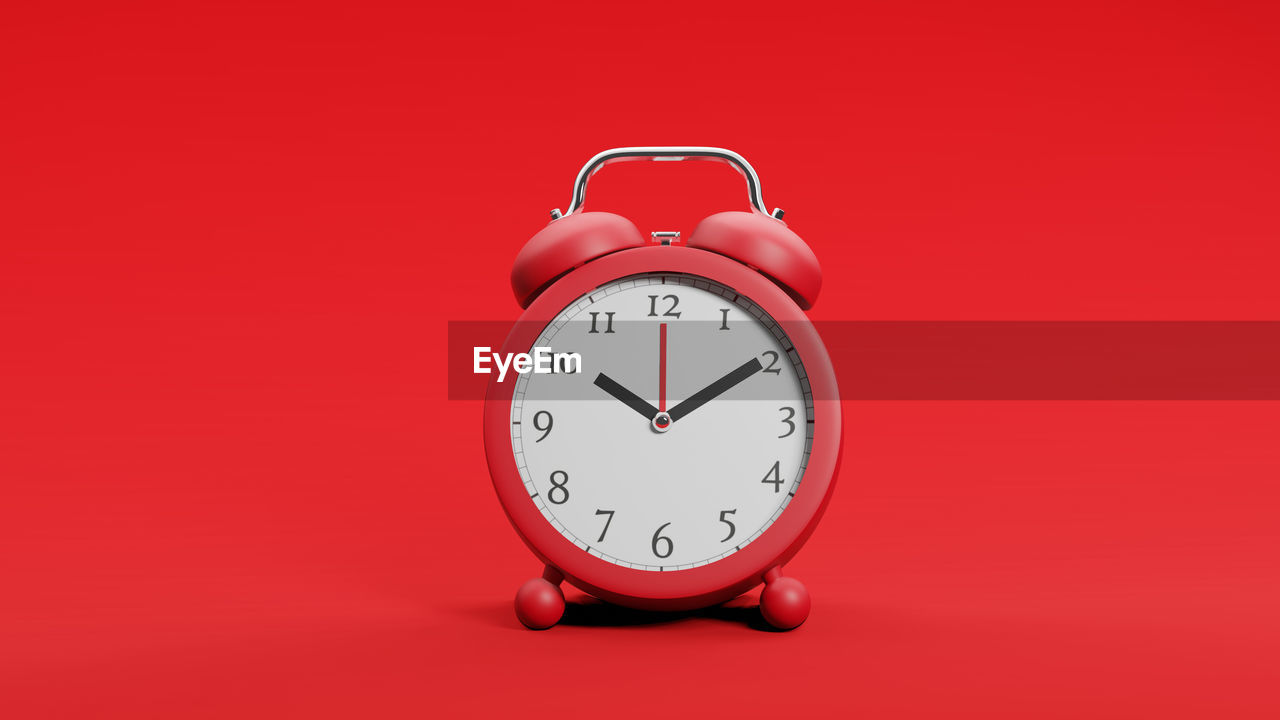 VIEW OF CLOCK ON RED BACKGROUND