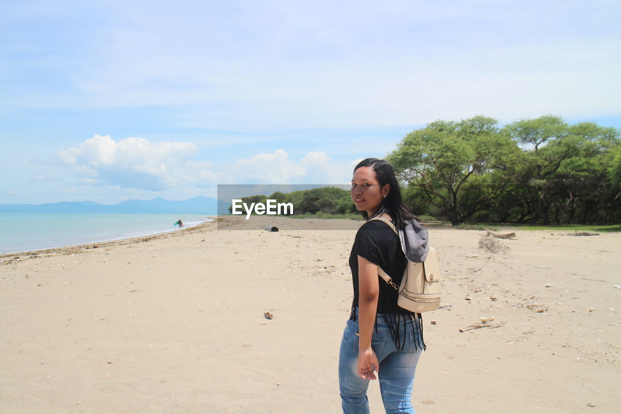 Portrait of woman walking at beach