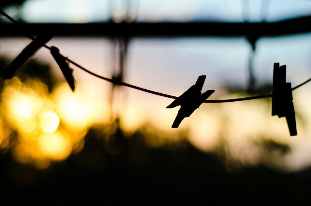 Silhouette of clothespin on clothesline