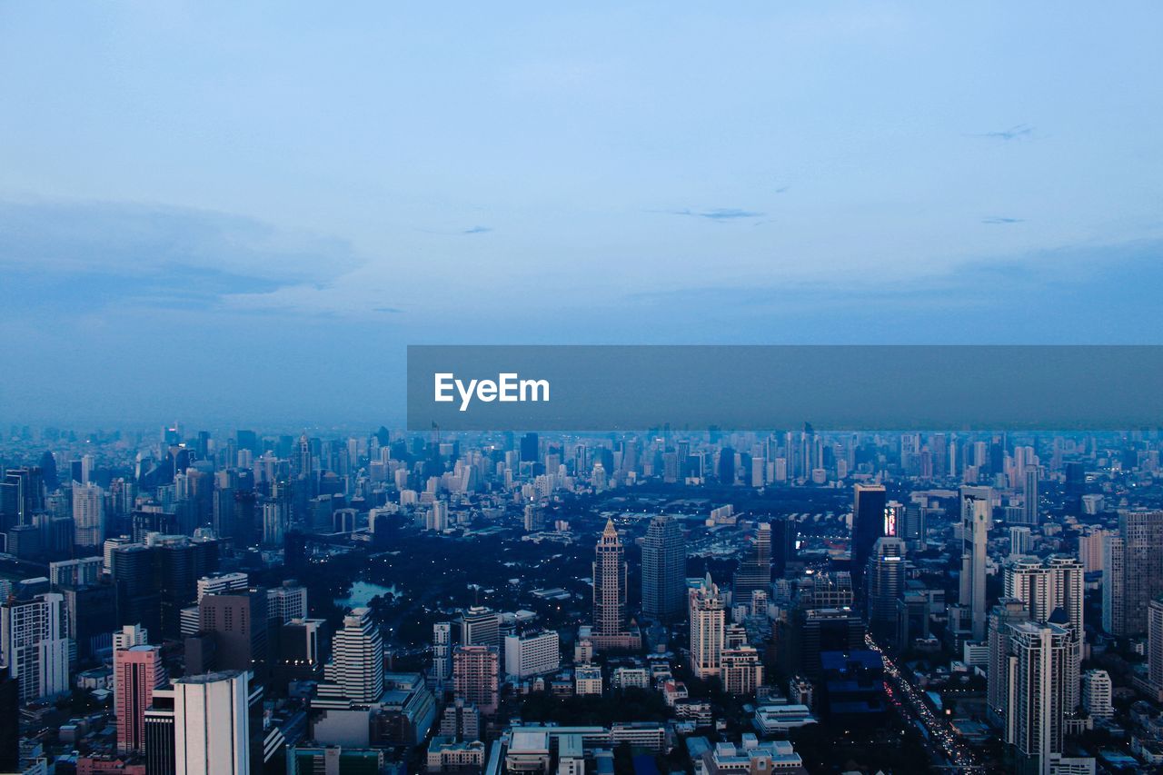 city, architecture, building exterior, cityscape, built structure, horizon, building, sky, office building exterior, skyscraper, landscape, skyline, urban skyline, metropolitan area, residential district, nature, travel destinations, city life, metropolis, dusk, no people, urban area, downtown district, cloud, high angle view, aerial photography, office, aerial view, outdoors, travel, development, blue, illuminated, business, evening, night, downtown, tower block