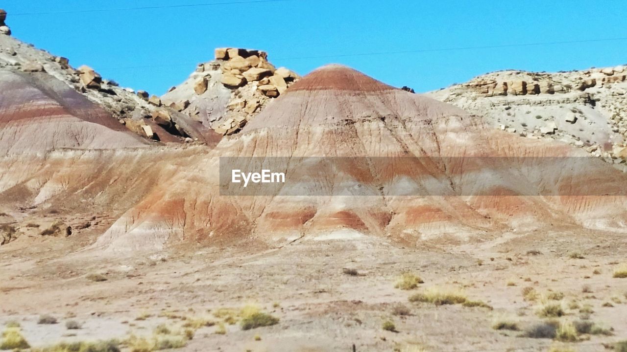 ROCKY LANDSCAPE AGAINST CLEAR BLUE SKY