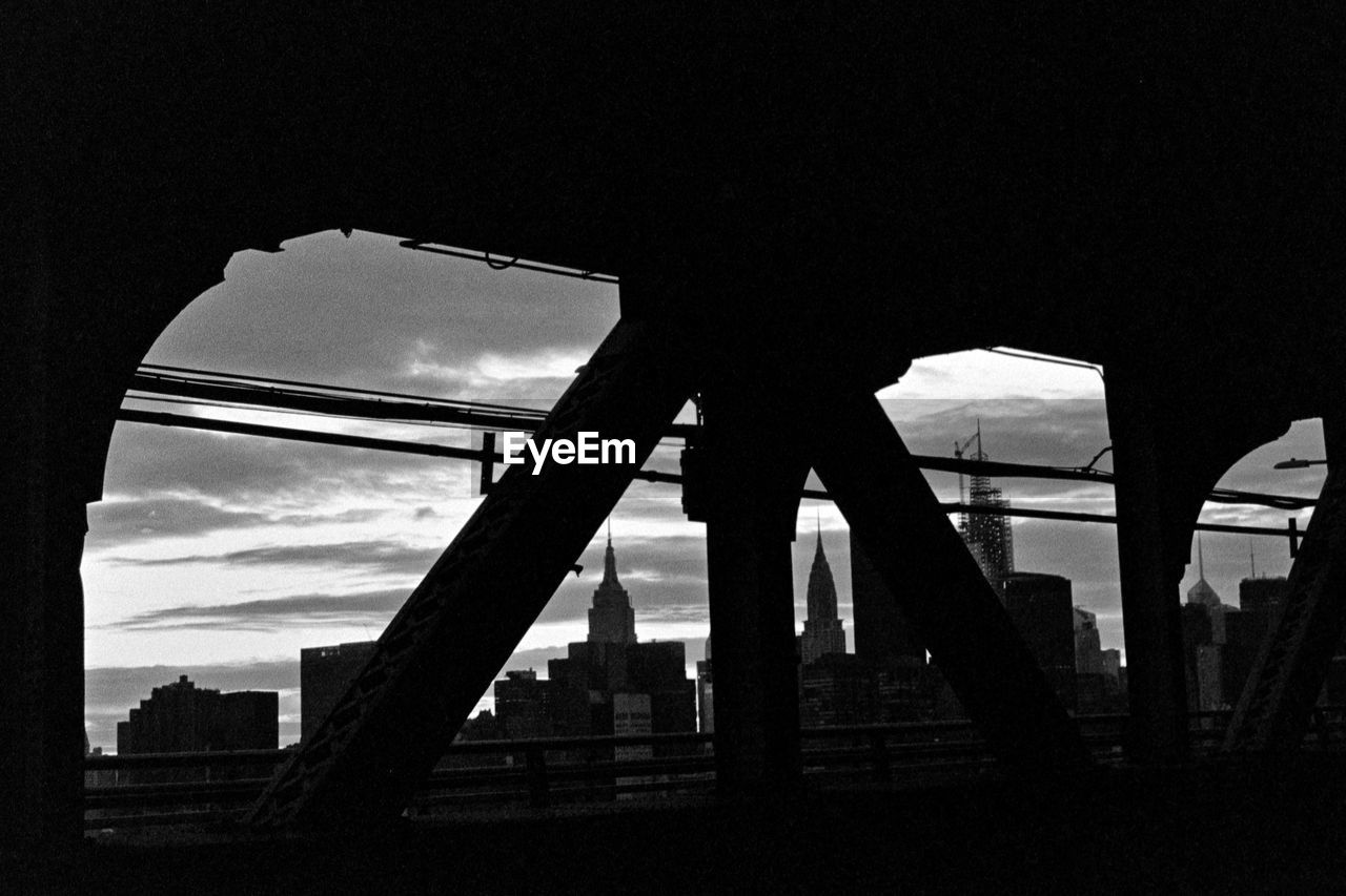 LOW ANGLE VIEW OF SILHOUETTE BRIDGE AGAINST SKY AT DUSK