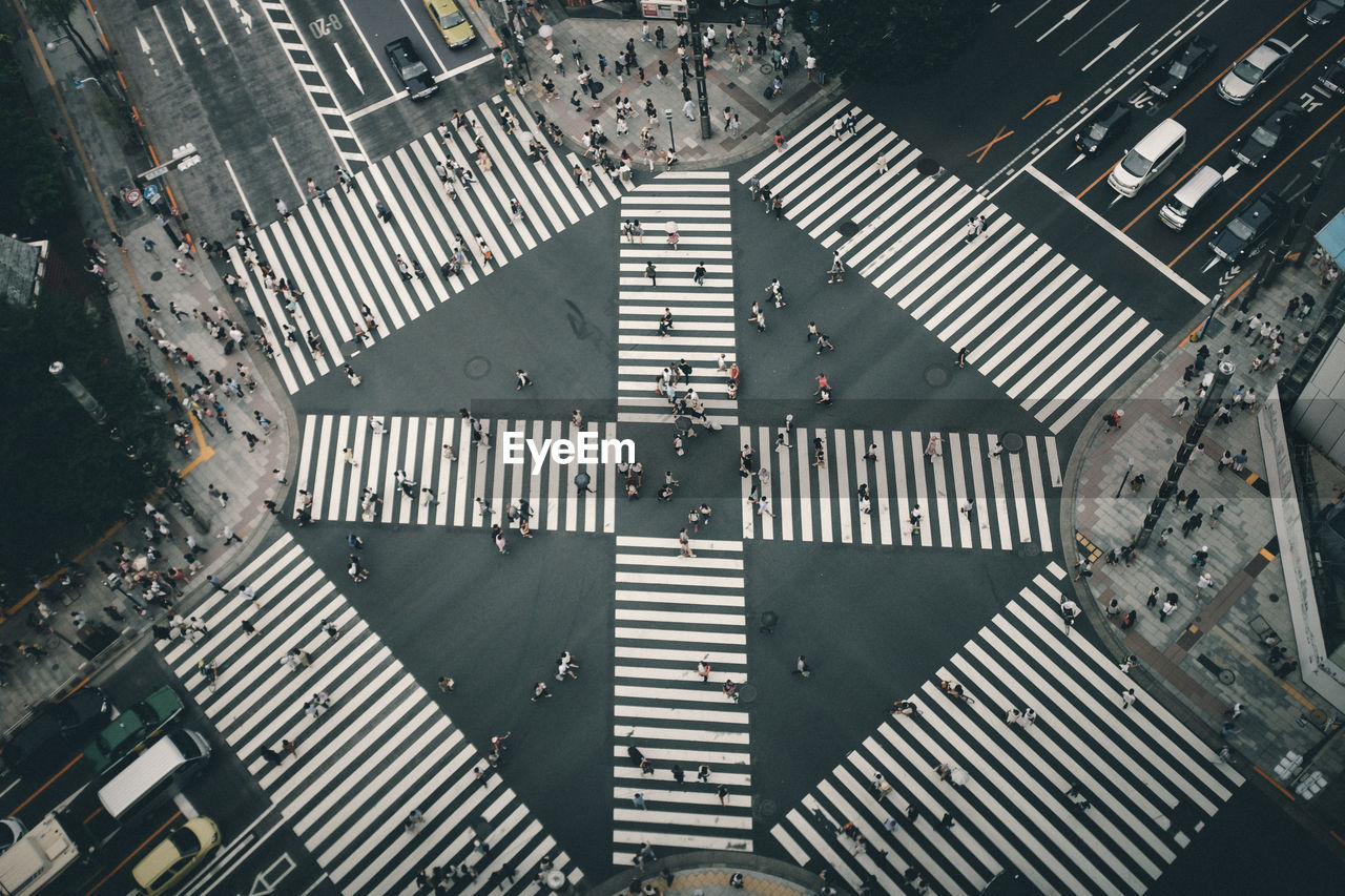 Aerial view of people walking on crosswalk in city