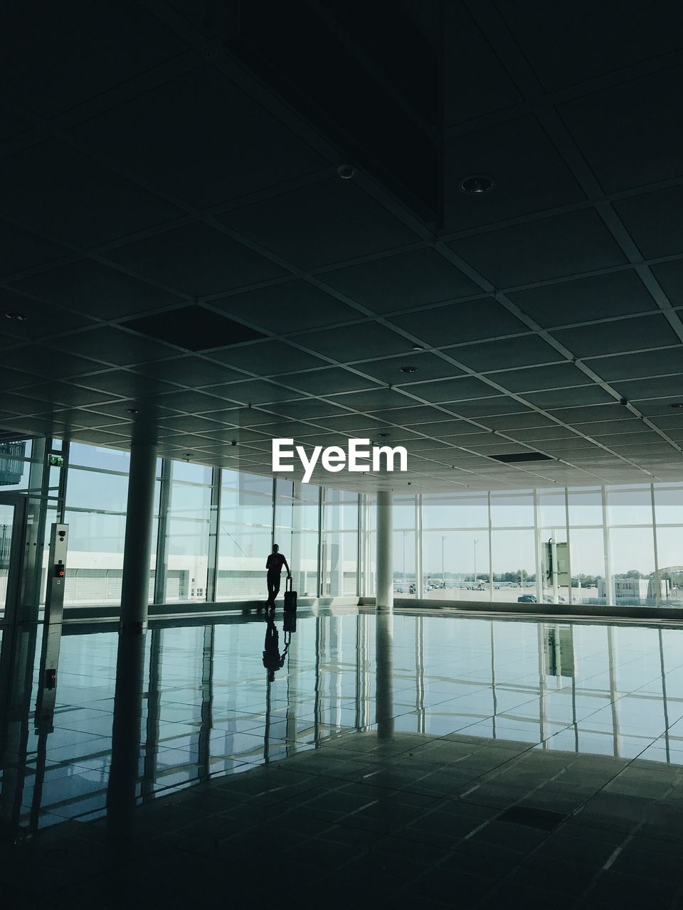 Silhouette man standing at airport 