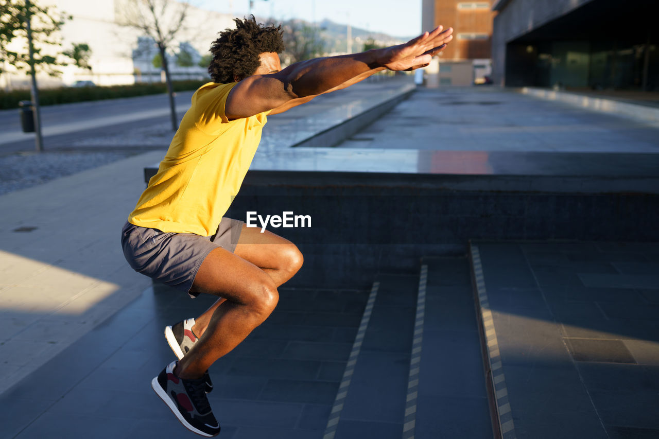 Man exercising on steps in city