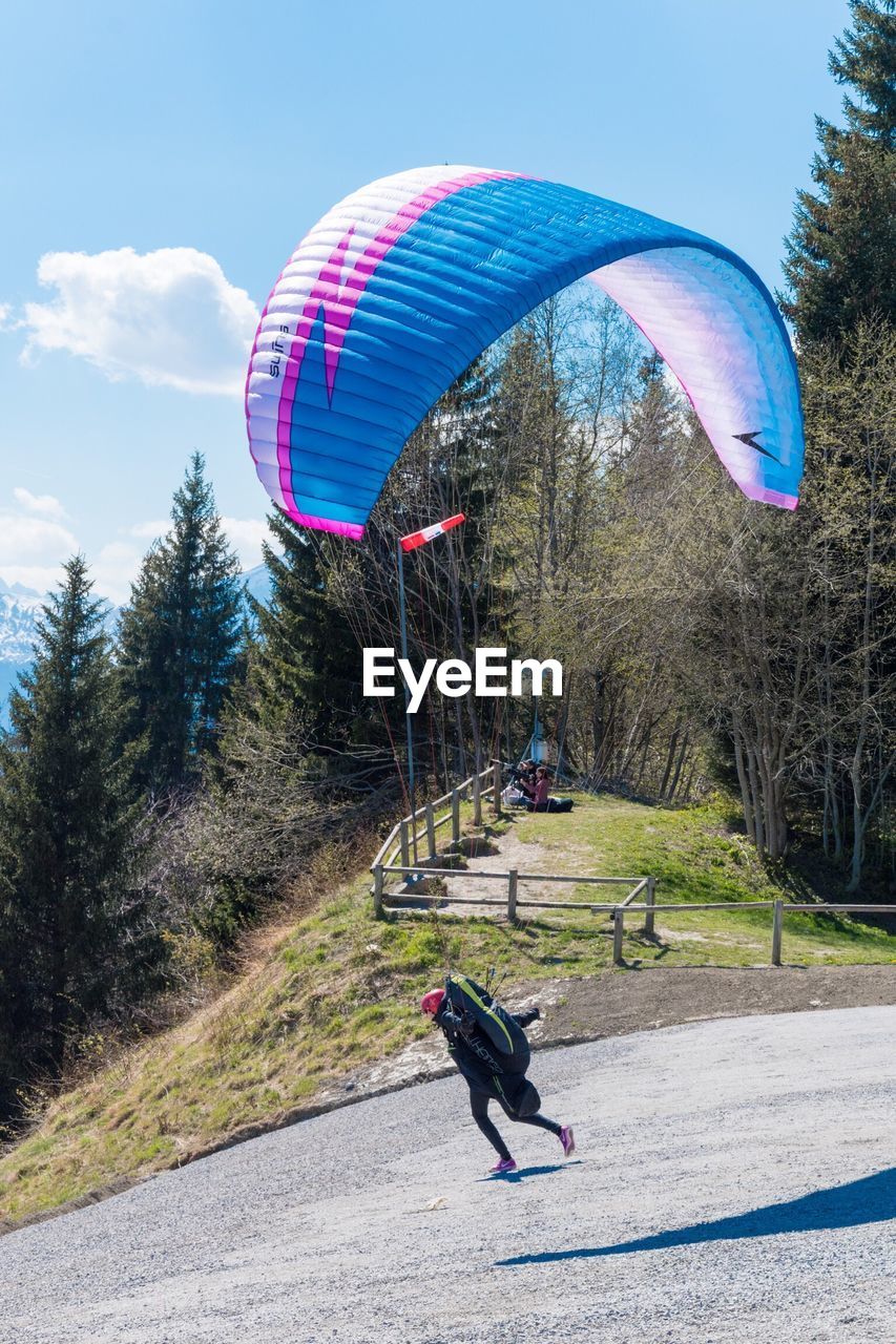 MAN WITH UMBRELLA IN MID-AIR