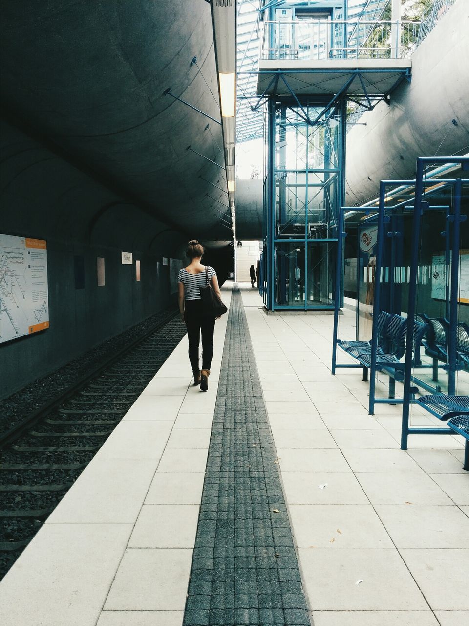 Back view of a young at metro station