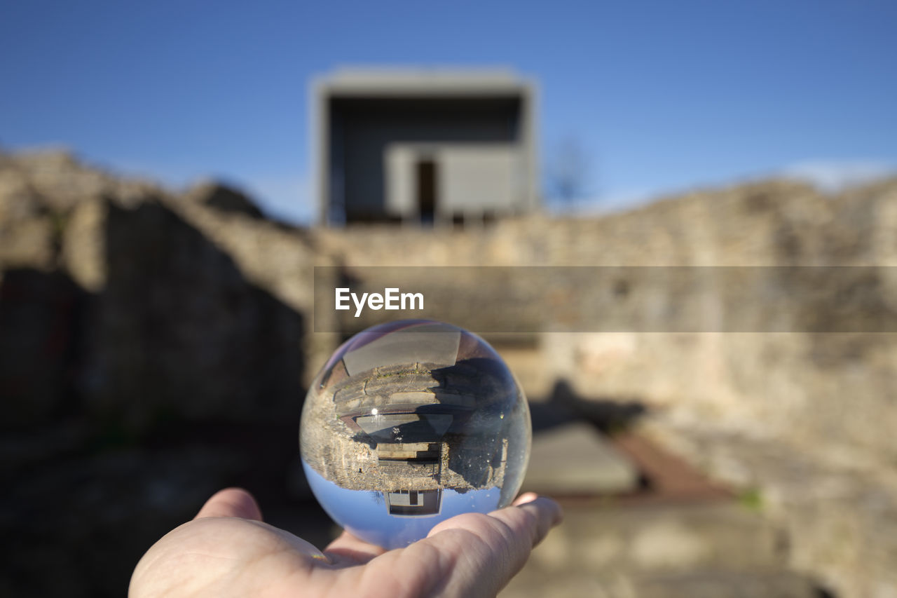 The villa of veranes is reflected over a glass sphere