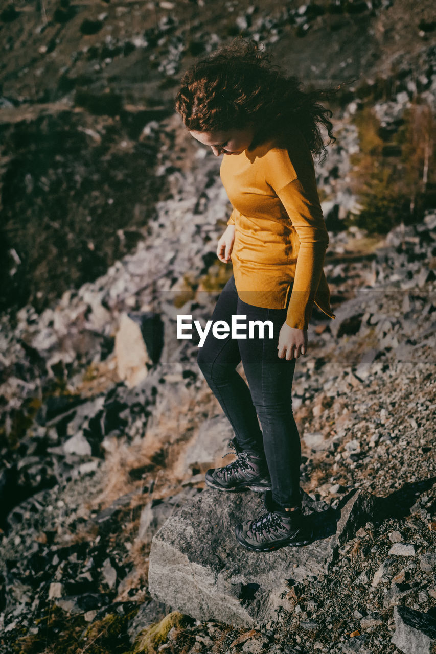 High angle view of woman standing on rock