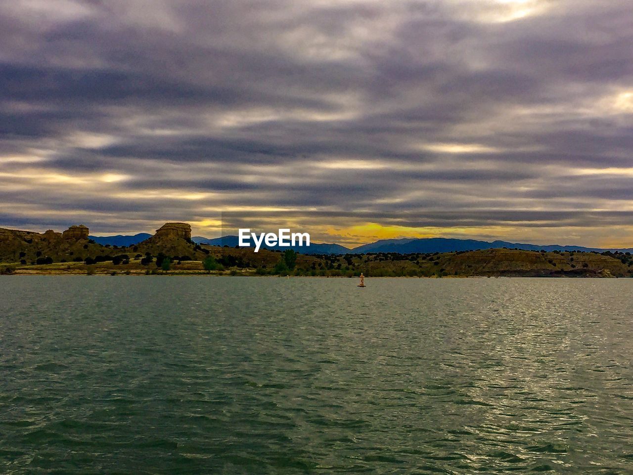 SCENIC VIEW OF SEA AND MOUNTAINS AGAINST SKY