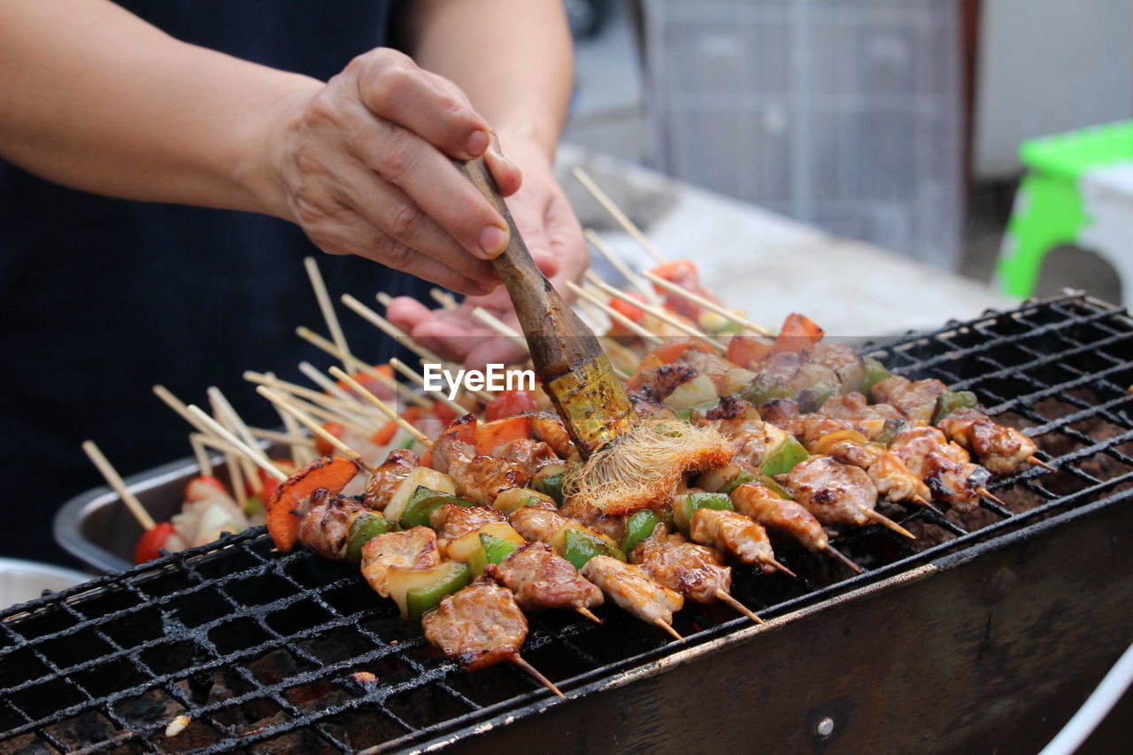 food, food and drink, barbecue, barbecue grill, hand, freshness, grilled, dish, grilling, meat, cooking, cuisine, skewer, preparing food, heat, street food, healthy eating, meal, wellbeing, one person, arrosticini, grid, serving tongs, seafood, adult, kebab, outdoor grill, outdoors, day, metal grate, grate, fast food, holding, asian food, women, lifestyles, pincho, domestic life