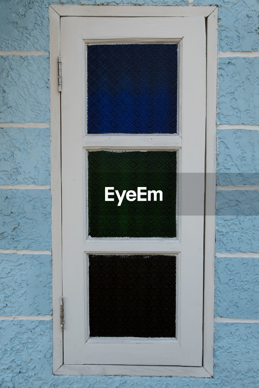 CLOSE-UP OF WINDOW ON WALL OF BUILDING