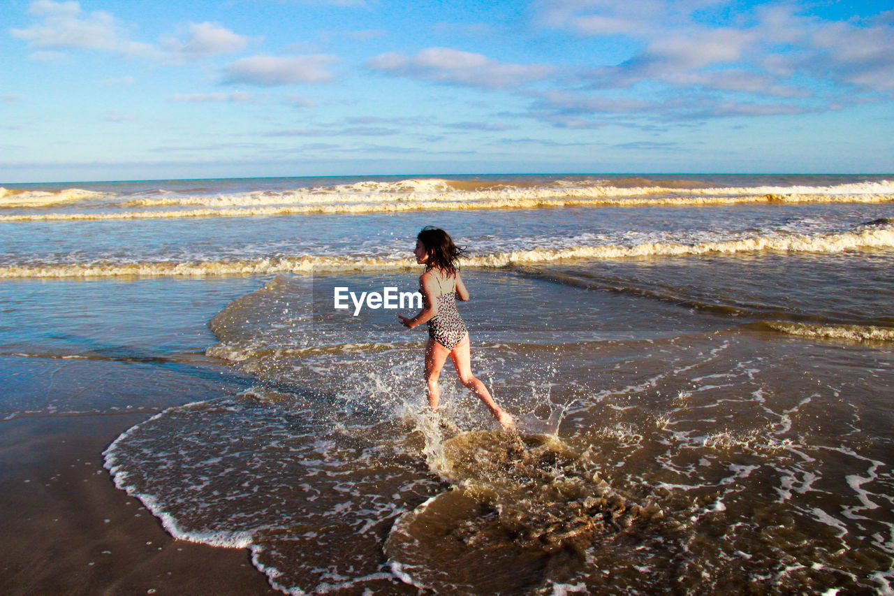 Girl running at shore