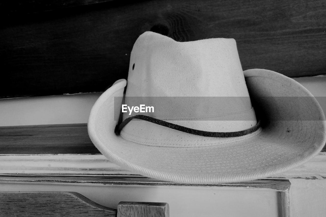 white, black, hat, black and white, fedora, monochrome, cowboy hat, monochrome photography, sun hat, fashion accessory, no people, wood, still life photography, indoors, still life, clothing, table