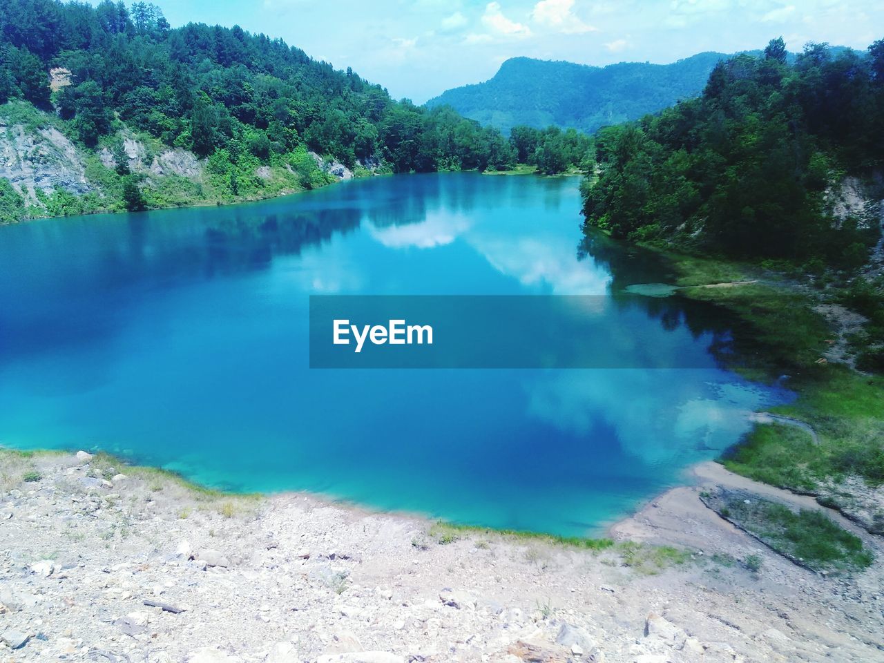 Scenic view of lake against cloudy sky