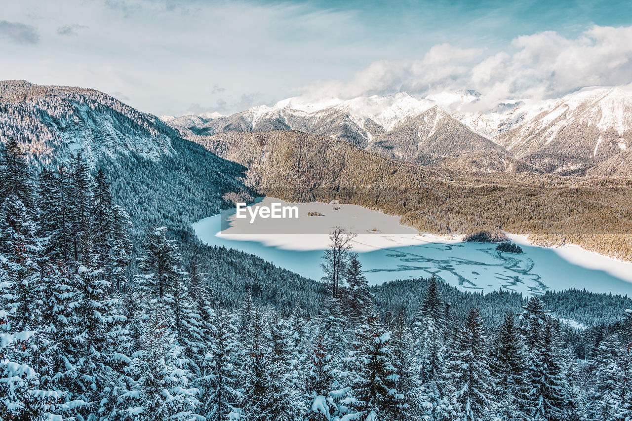 Snowy mountains and trees in the alps. view of the lake eibsee. germany.