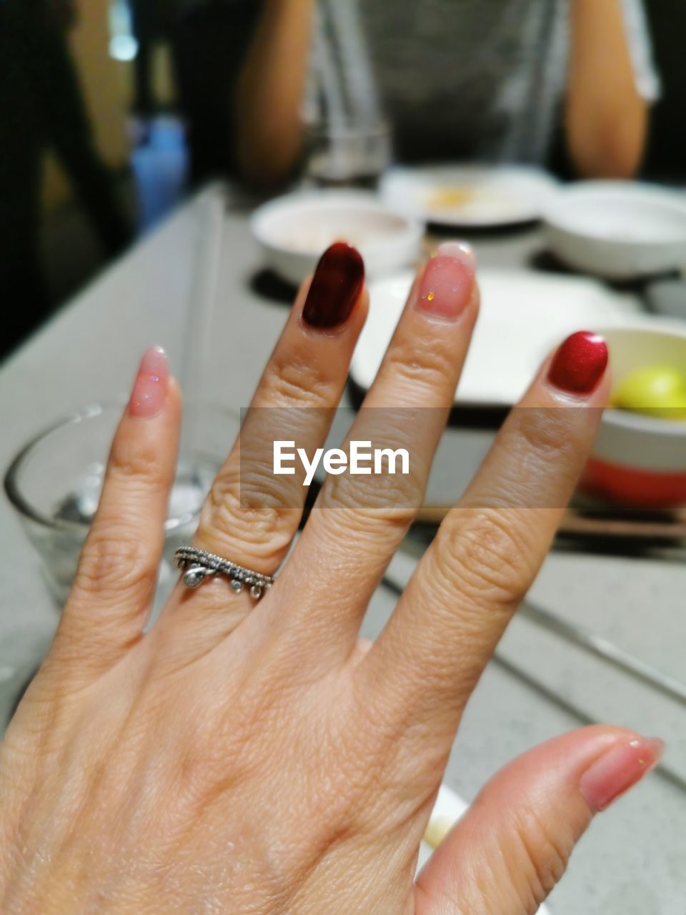 CLOSE-UP OF HANDS OF WOMAN HAND WITH TATTOO