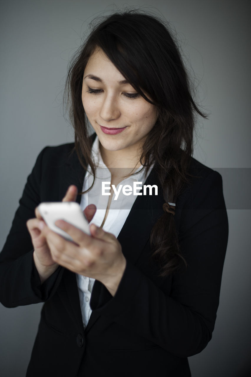 Young businesswoman using smartphone