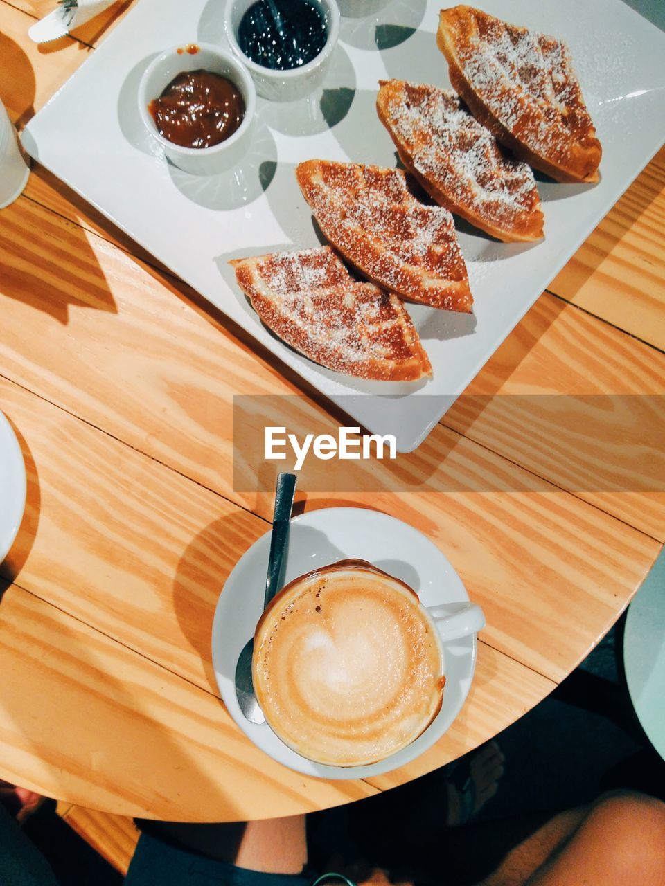 High angle view of coffee with food on wooden table
