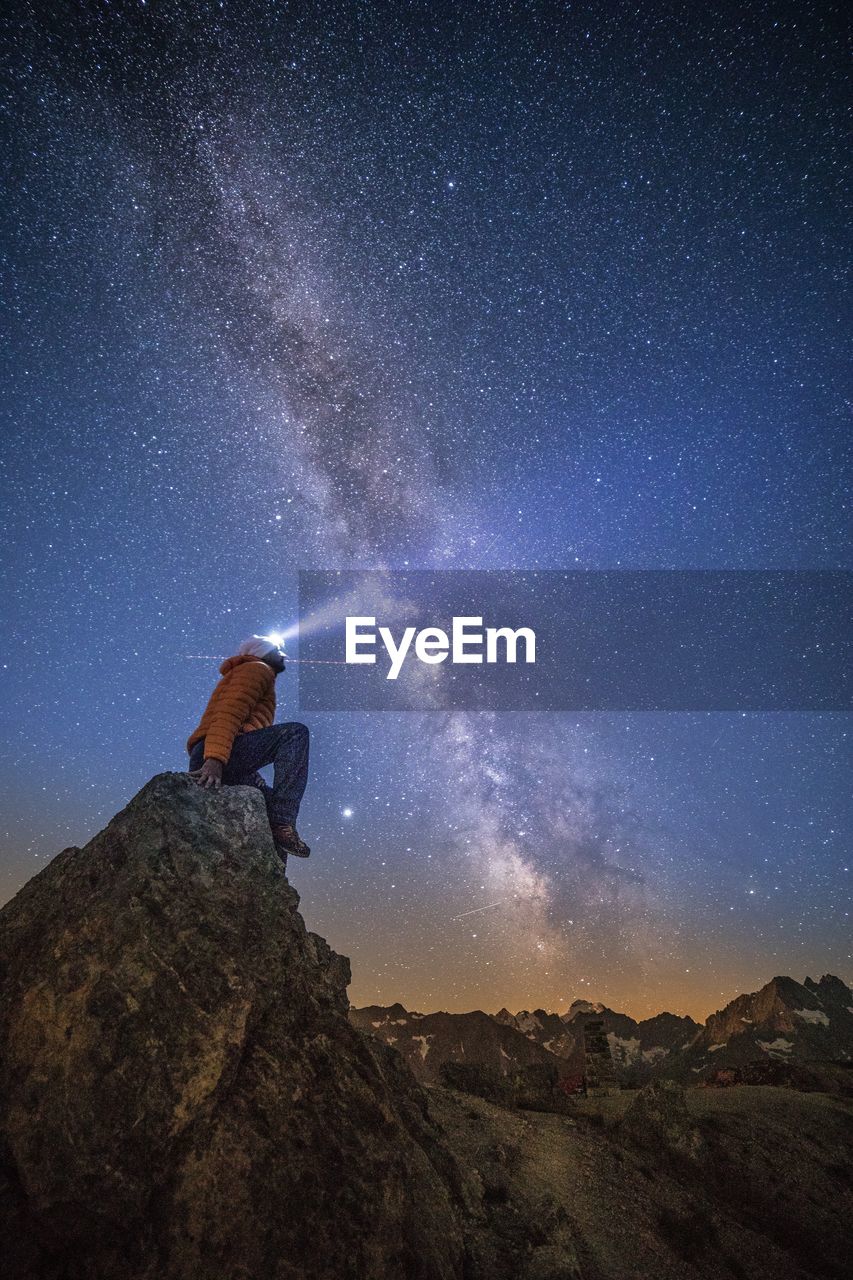 Scenic view of rock against sky at night