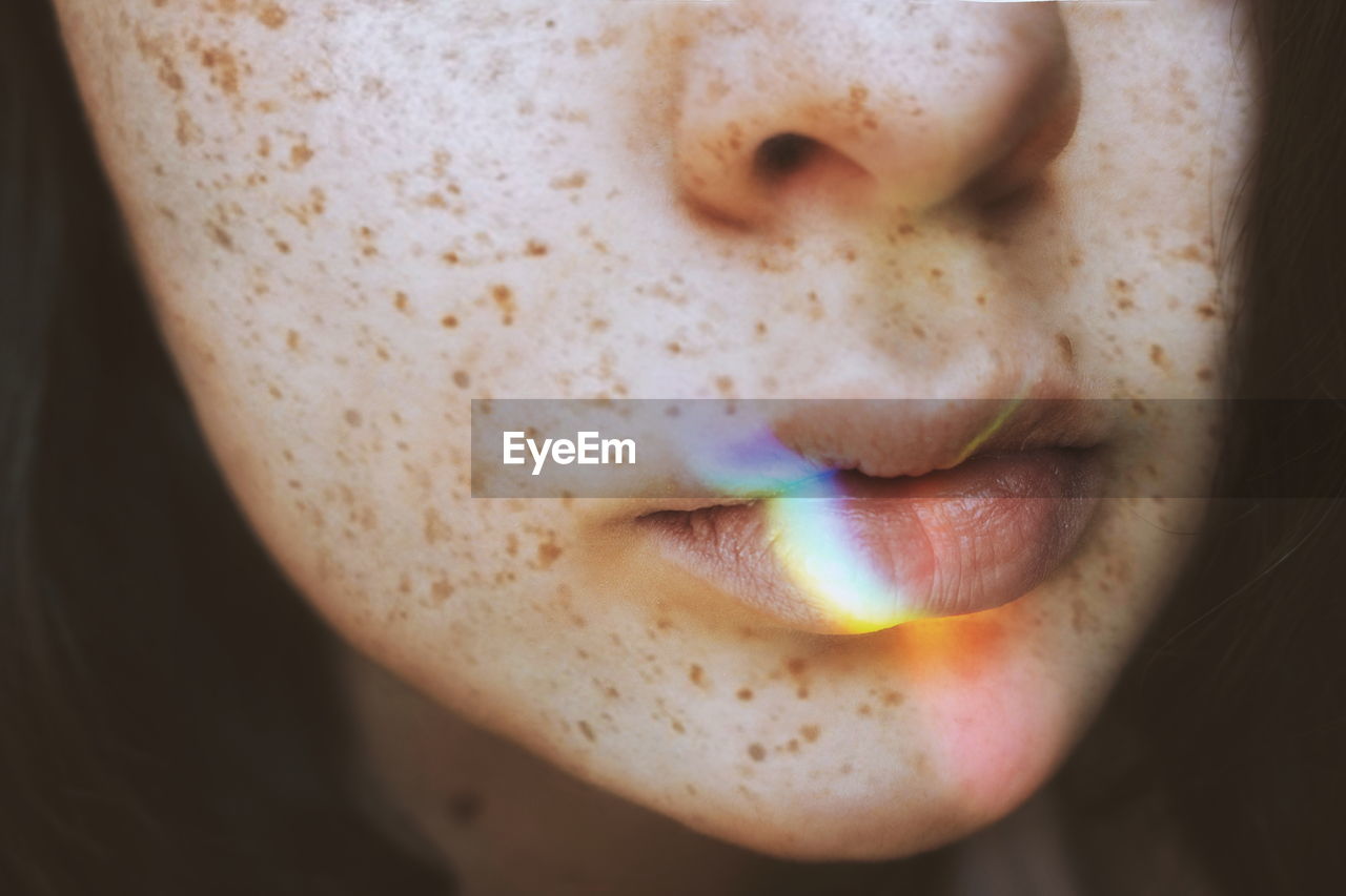 Close-up of spectrum on woman lips